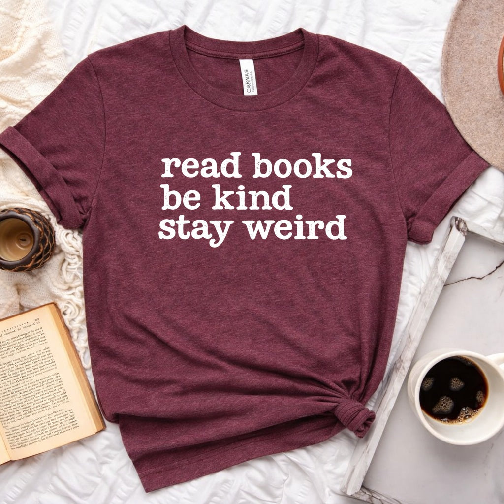 Read Books Be Kind Stay Weird distressed text graphic on a unisex crew neck tee for book lovers