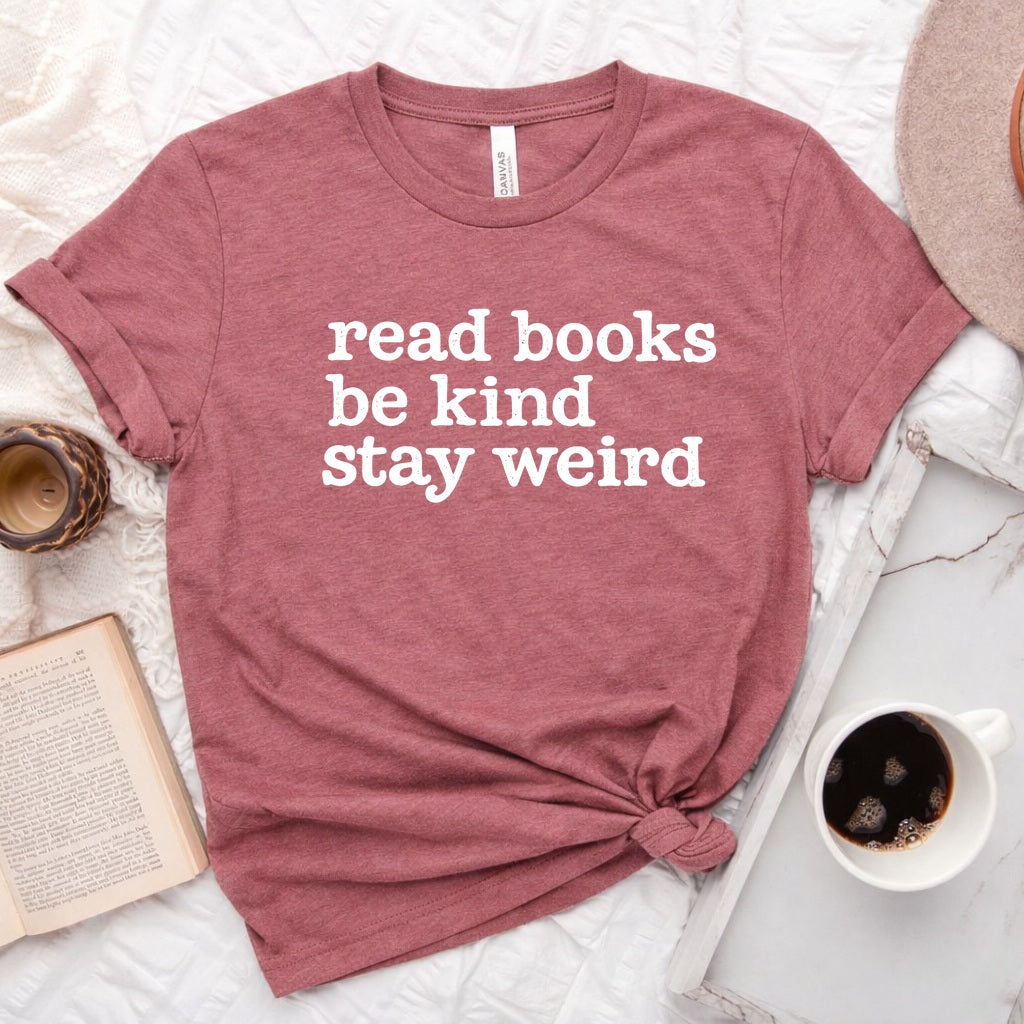 Read Books Be Kind Stay Weird distressed text graphic on a unisex crew neck tee for book lovers