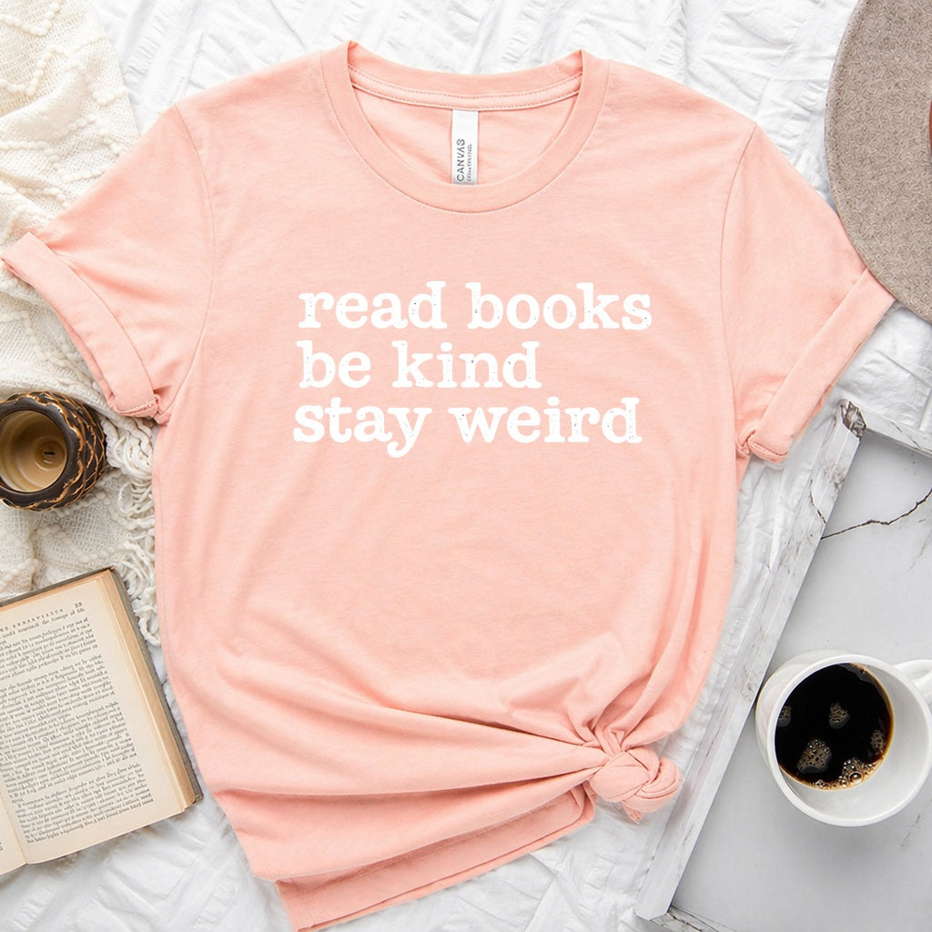 Read Books Be Kind Stay Weird distressed text graphic on a unisex crew neck tee for book lovers