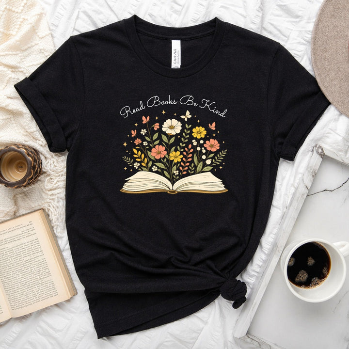 Unisex book lover tee featuring a vintage-style open book with wildflowers, cosmos, and butterflies blooming from the pages