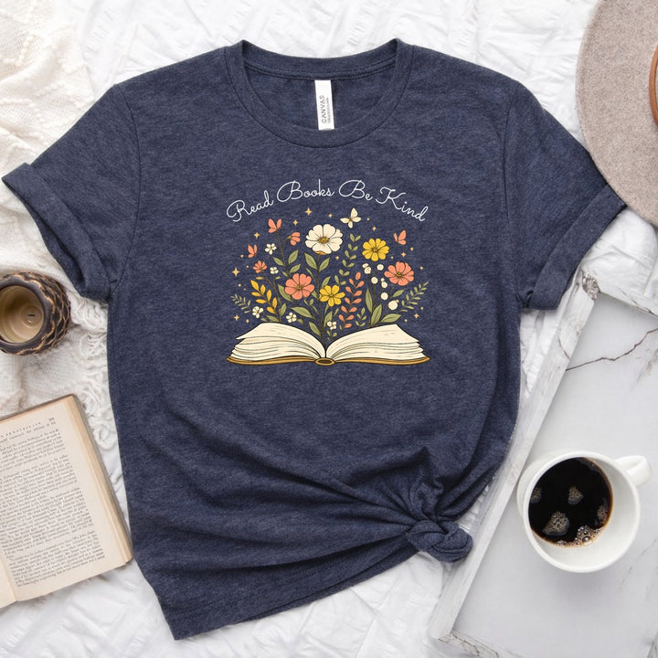 Unisex book lover tee featuring a vintage-style open book with wildflowers, cosmos, and butterflies blooming from the pages
