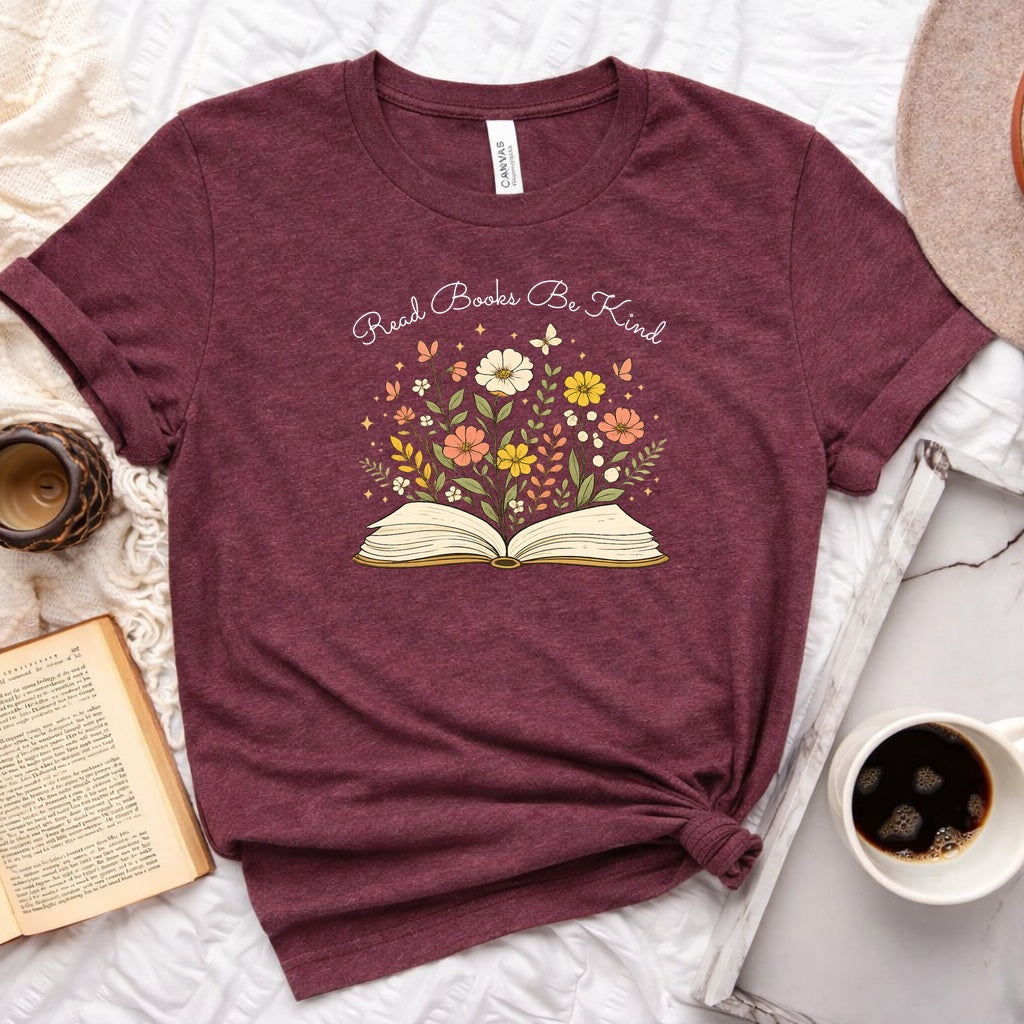Unisex book lover tee featuring a vintage-style open book with wildflowers, cosmos, and butterflies blooming from the pages