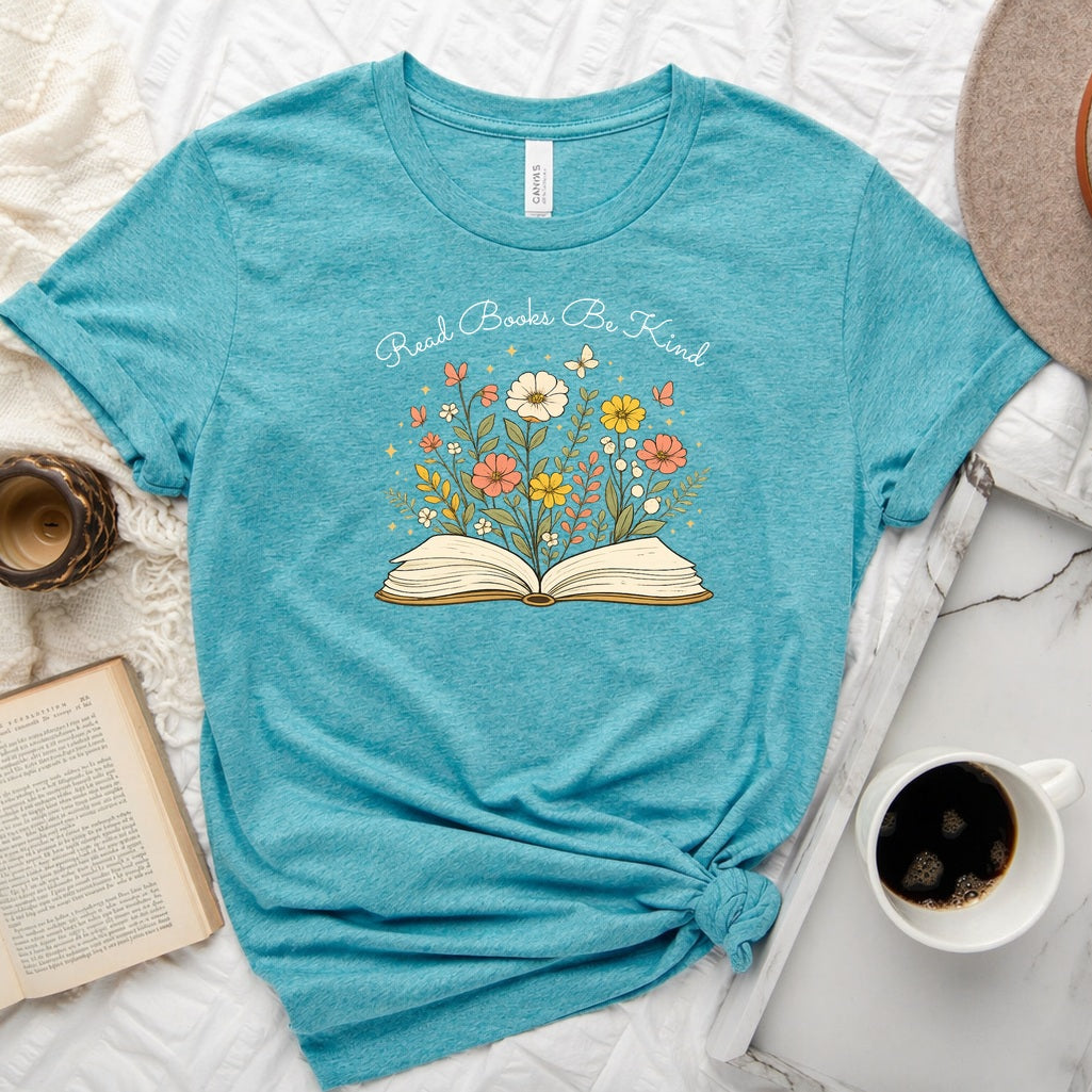 Unisex book lover tee featuring a vintage-style open book with wildflowers, cosmos, and butterflies blooming from the pages