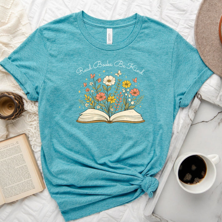 Unisex book lover tee featuring a vintage-style open book with wildflowers, cosmos, and butterflies blooming from the pages