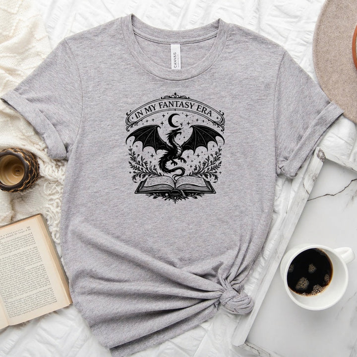 In My Fantasy Era unisex tee with dragon, crescent moon, stars and open book design for book lovers