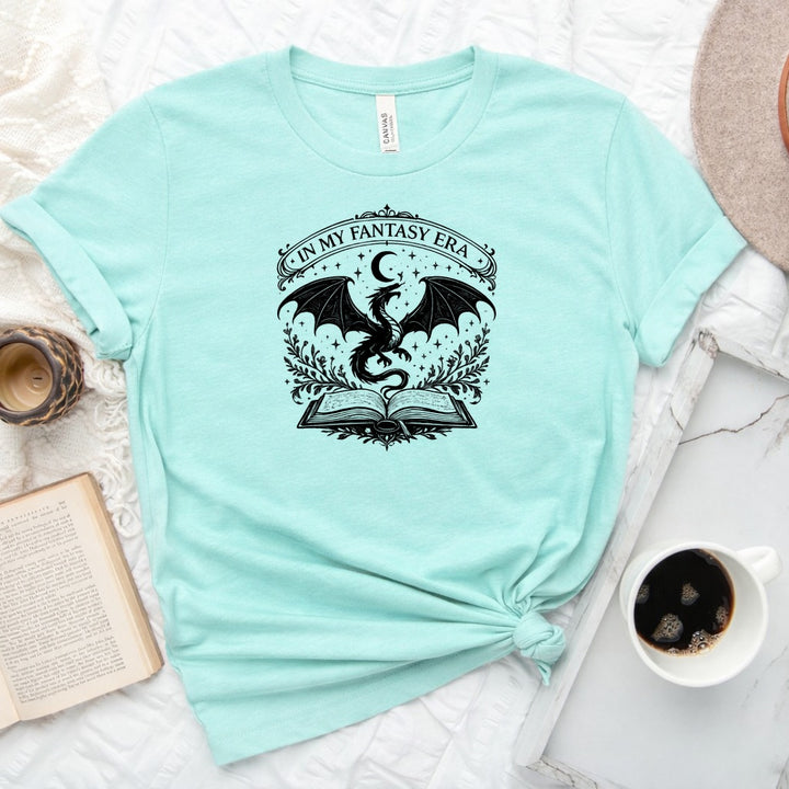 In My Fantasy Era unisex tee with dragon, crescent moon, stars and open book design for book lovers