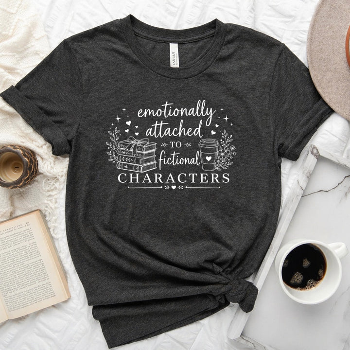 Emotionally attached to fictional characters bookish graphic unisex tee with stacked books and floral wreath design