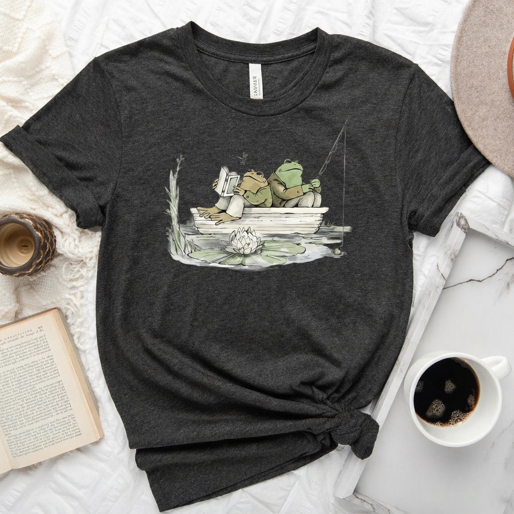 Frog reading and fishing graphic on a soft unisex crew neck tee, perfect for book lovers