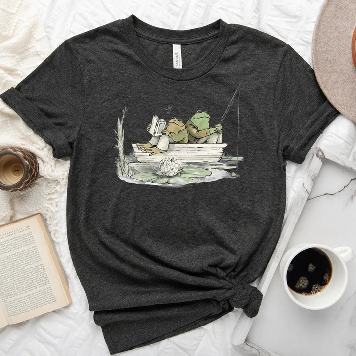 Frog reading and fishing graphic on a soft unisex crew neck tee, perfect for book lovers