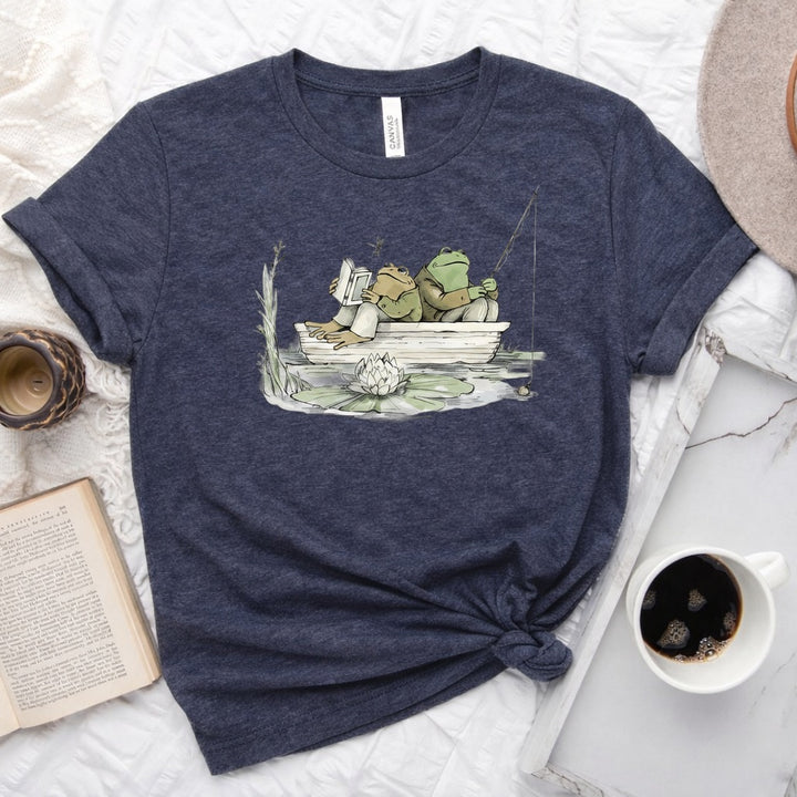 Frog reading and fishing graphic on a soft unisex crew neck tee, perfect for book lovers