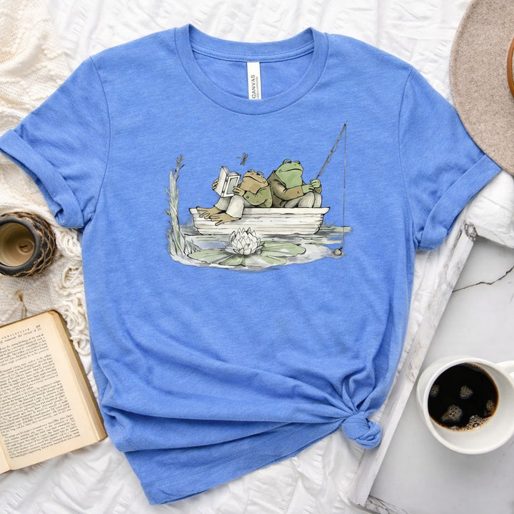 Frog reading and fishing graphic on a soft unisex crew neck tee, perfect for book lovers