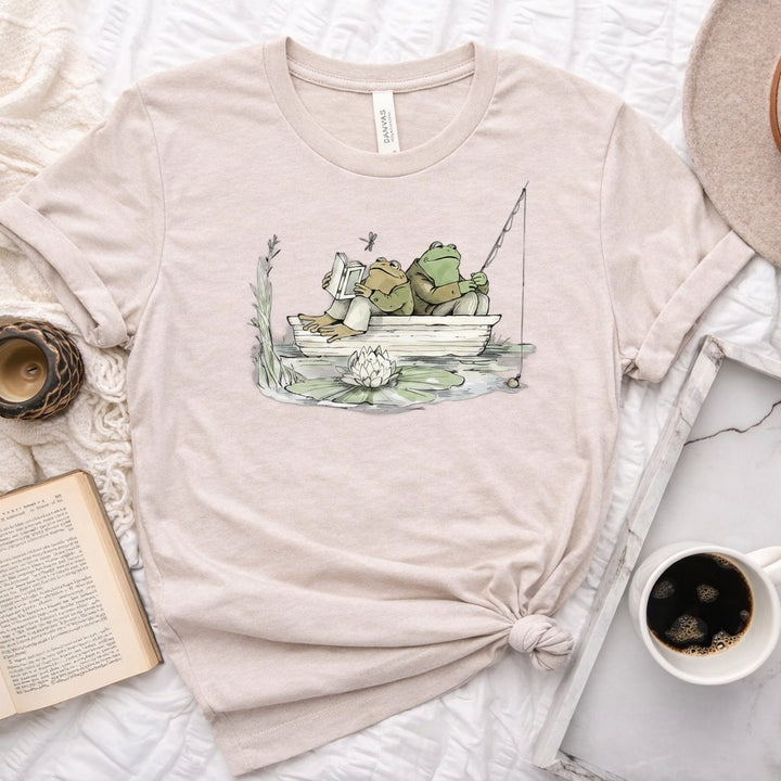 Frog reading and fishing graphic on a soft unisex crew neck tee, perfect for book lovers