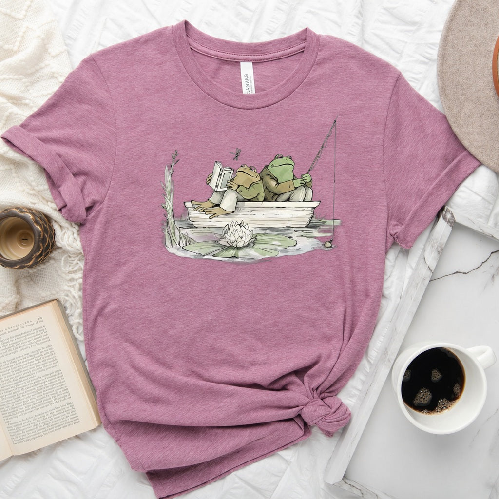 Frog reading and fishing graphic on a soft unisex crew neck tee, perfect for book lovers